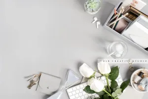 Roses & Hourglass on Grey Workspace. Stock Image